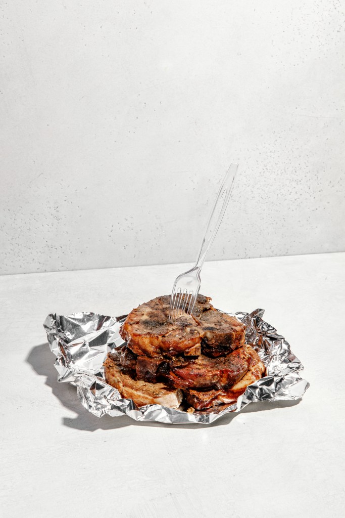 slow-roasted pork chop in aluminum foil wrap